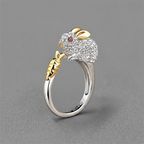 Silver and gold ring with a decorative design on a gray background