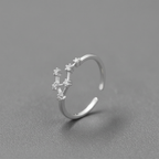 Silver ring with gemstones on a gray background