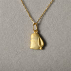 A sterling silver pendant necklace with a gold-tone rabbit design.