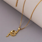 A gold-colored snake-shaped pendant necklace with a long chain.